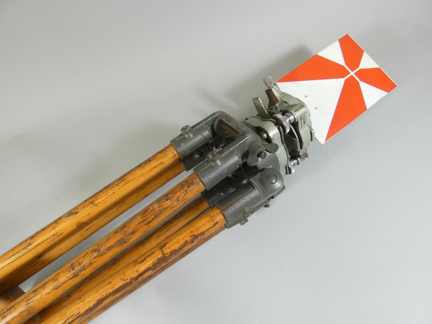 A pair of vintage surveyors measuring tools, with red and white level gauges, on wooden tripod - Image 2 of 5