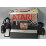 A boxed Atari 2600 JR personal computer, serial No. AT850086907, with PSU, new style controller,