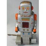A wind-up tin clockwork walking robot, made in Japan by S.Y. Co., circa 1950?s, with red sparkling