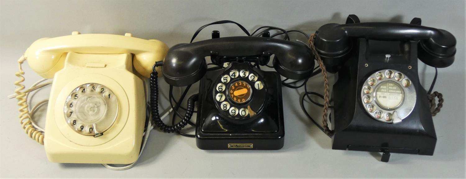 A GPO Bakelite black telephone, '164 63' to the receiver, together with a similar Bakelite telephone