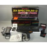 A boxed Sinclair ZX Spectrum+2 Action Pack, with power supply unit, television lead, manual, light