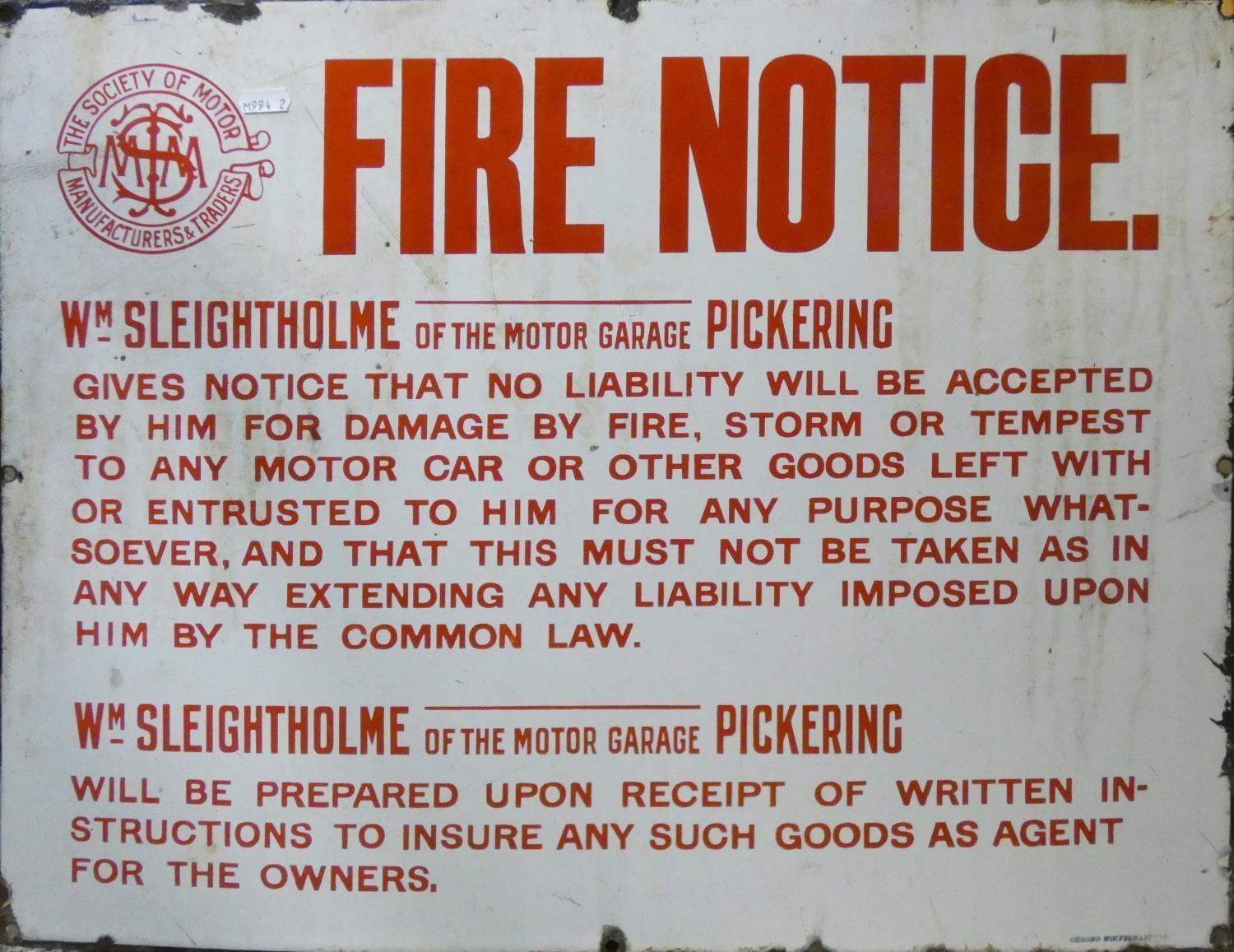 An enamel sign 'Fire Notice, for WM Sleightholme of the motor garage Pickering, 64 x 51cm.