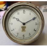 A Smiths vintage dash board clock, silvered dial, hinged to allow winding, diameter 9 cm.