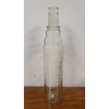 A clear glass Essolube 1 quart oil bottle, 39 cm.