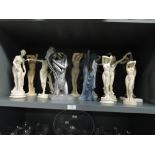 A collection of resin nude figures