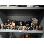 A herd of hand carved African and similar elephants including Ethnic woods and ceramic