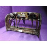 A tobacco smokers pipe rack and selection of pipes including HM silver rimmed