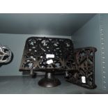 A cast iron recipe stand and similar trivet