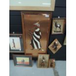 A selection of African themed wall plaques and prints