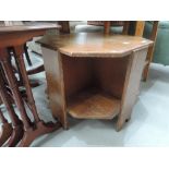 An early to mid 20th Century golden oak octagonal coffee table/bookshelf