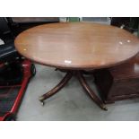 A 19th century refurbished pedestal table having circular crossband top on bulbous column and