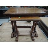 A traditional oak nest of three tables