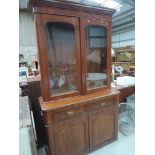 A late Victorian mahogany full height bookcase having glass combined top over double drawer and door