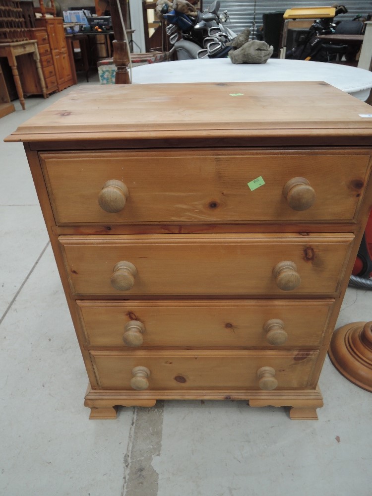 A modern pine chest of 4 drawers