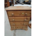 A modern pine chest of 4 drawers