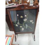 A 1920's mahogany frame firescreen having embroidered bird and branch inset