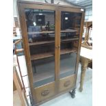 An early to mid 20th Century oak display cabinet