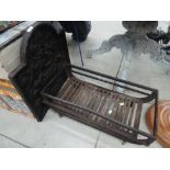 A traditional cast dog fire grate