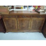 A reproduction Regency style sideboard and similar dining table
