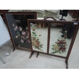 A 1920's oak frame firescreen having embroidered bird and foliage inset and a painted mirror inset