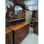 A late Victorian mahogany full height sideboard having triple mirror and crest back over foliate