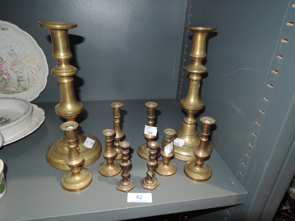 A selection of brass candle sticks of various designs