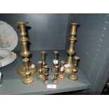 A selection of brass candle sticks of various designs