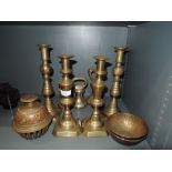 A selection of antique candle sticks including diamond and graduated weight set
