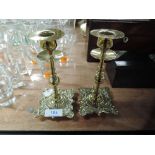 A pair of antique styled candle sticks of small form