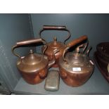 A selection of copper stove kettles and similar