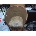 A woven fibre tub chair and stained frame trolley