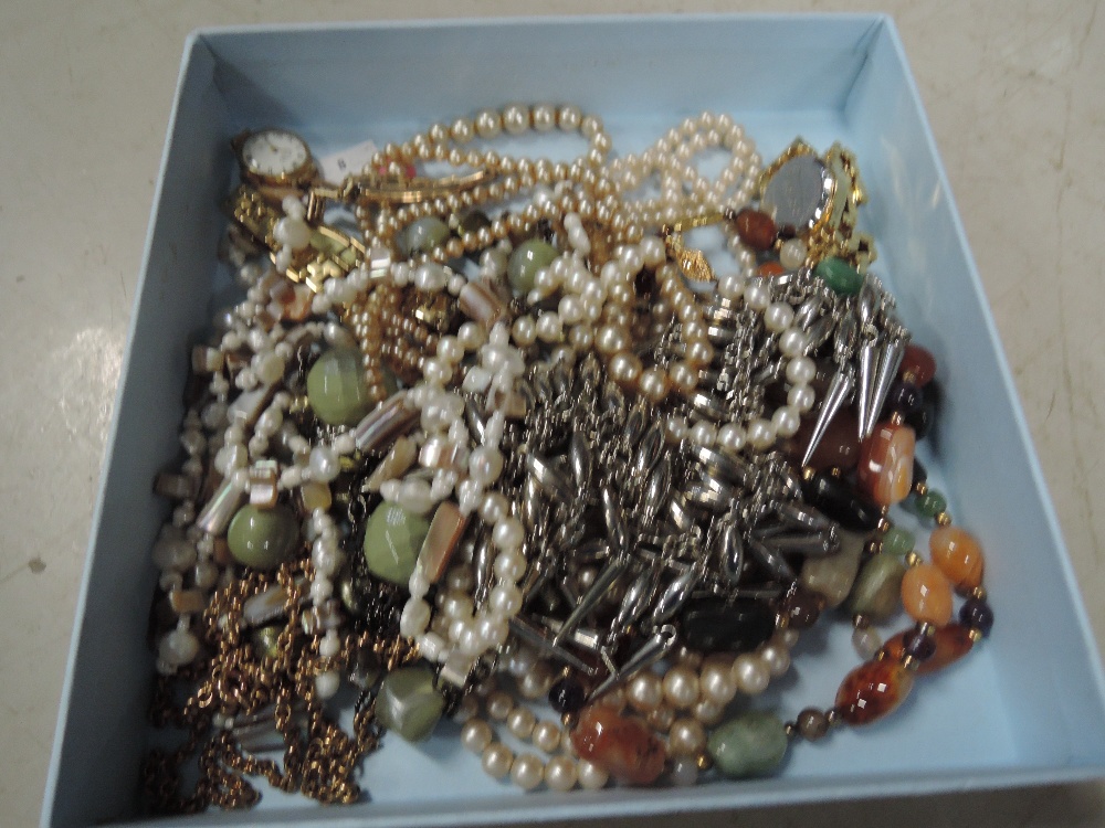 A small selection of costume jewellery including wrist watches and strings of beads