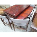 A set of four vintage stained frame Danish Dyrlund dining chairs and a rosewood effect dining