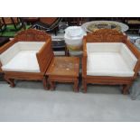 A pair of Thai hardwood throne style chairs, with matching occasional table, heavily carved elephant