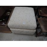 An upholstered footstool/ottoman
