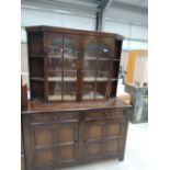 A mid 20th Century oak sideboard/dresser having glazed upper section