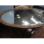 An oval gilt frame wall mirror