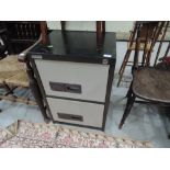 A vintage metal two drawer filing cabinet