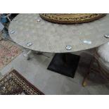 An industrial style garden table having chequer plate top