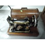 A vintage hand cranked Singer sewing machine