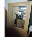 A beech effect framed mirror