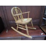A vintage beech child's rocking chair
