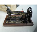 A hand cranked singer sewing machine