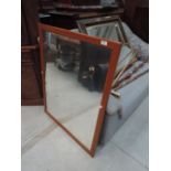 A modern stained frame wall mirror