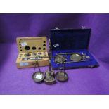 A selection of gold opium or similar small weight scales including brass balance set