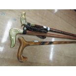 A selection of walking sticks with brass animal head handles