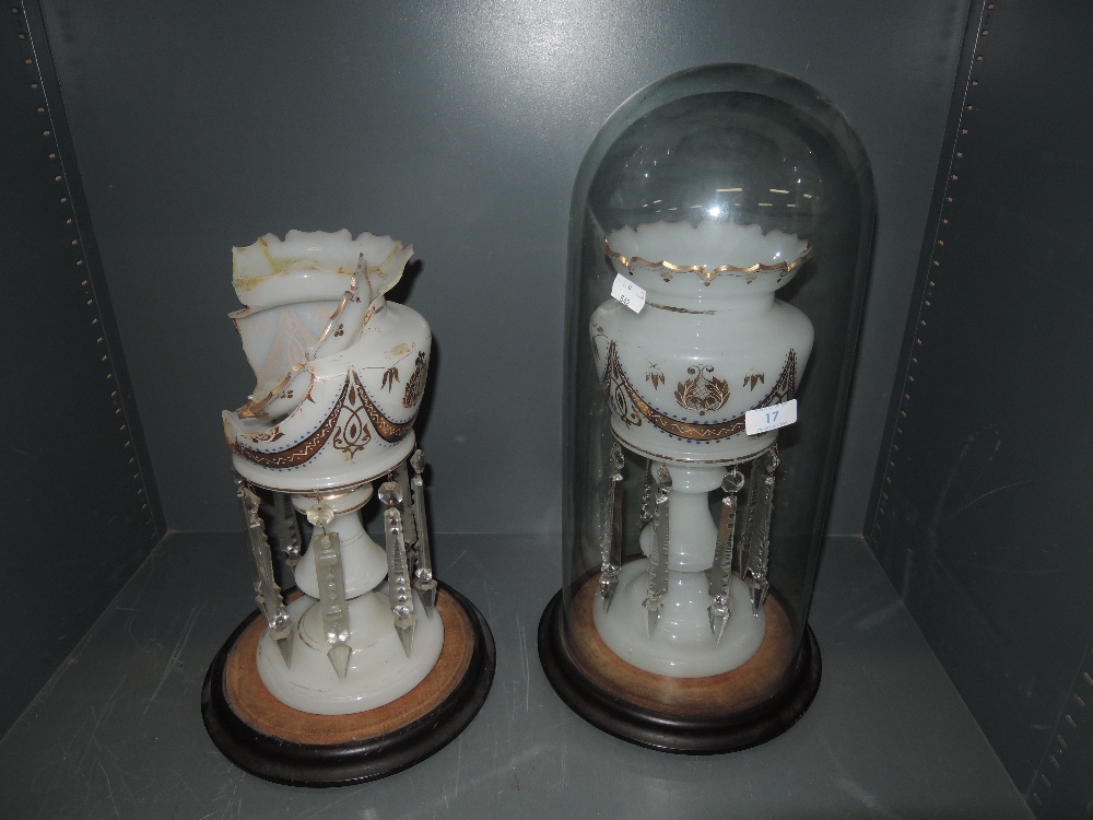 A Victorian mantle garniture with milk glass, lustre droplet and gold detailing in glass dome