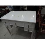 A vintage painted lift top dressing table