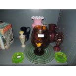 A selection of hand decorated glass wares including cranberry
