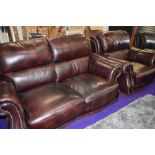 A modern brown leather settee and chair